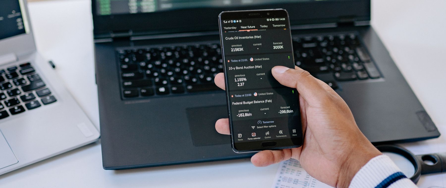 Trading on a laptop and a smartphone